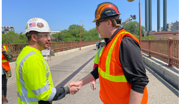 LIUNA General President Brent Booker Greets Local 563 member during Stone Arch Bridge visit in Minneapolis, MN