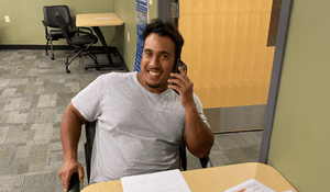 A man smiling on the phone.