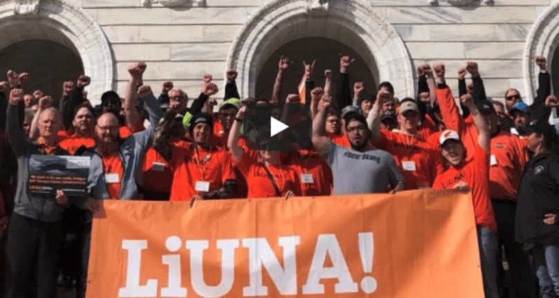 Video thumbnail of Liuna members putting their fists in the air behind a Liuna sign.