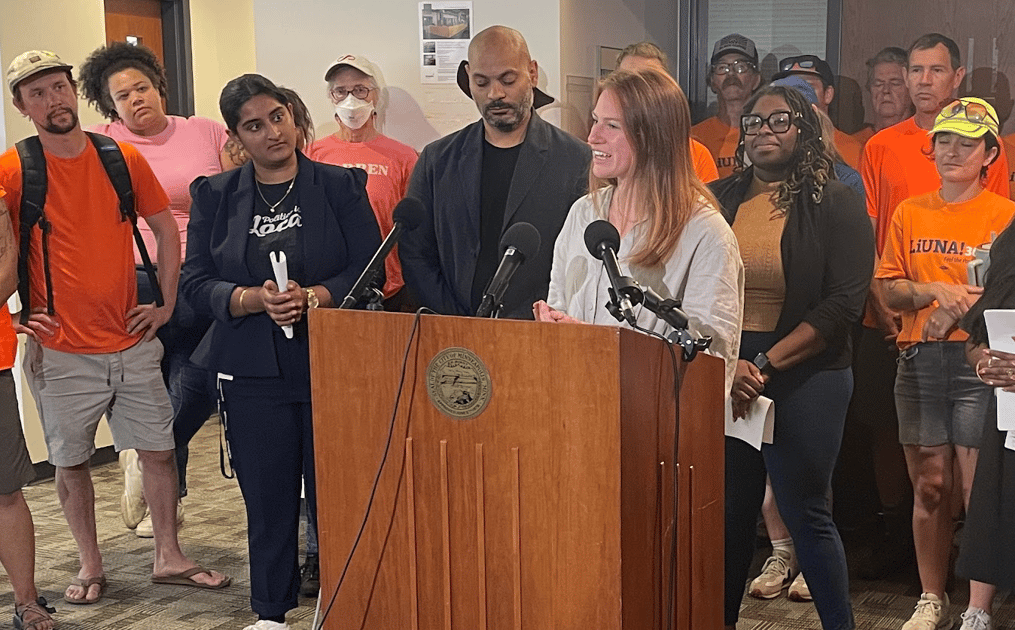 Katie Cashman speaking at press conference announcing pro-worker resolution