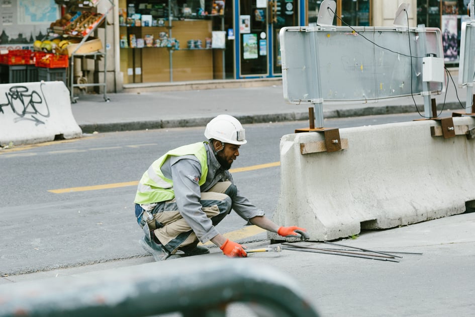 Construction worker repairing street infrastructure.