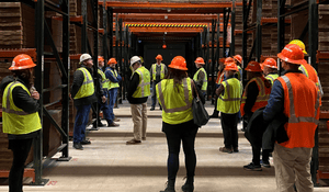 Group of construction workers standing in a factory. 