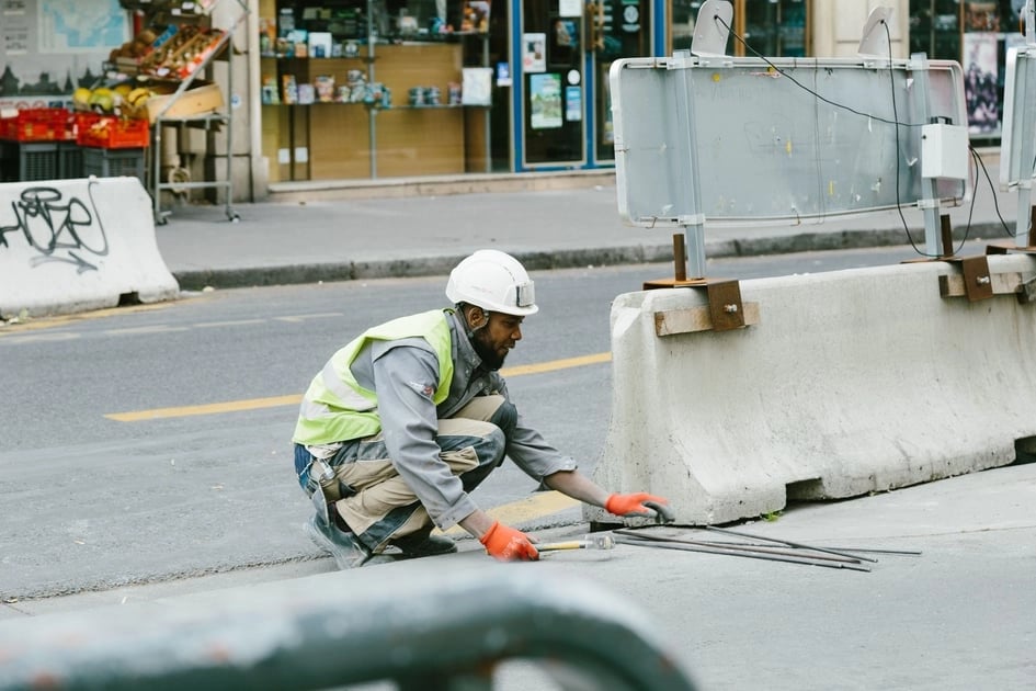 Construction worker paving a street.